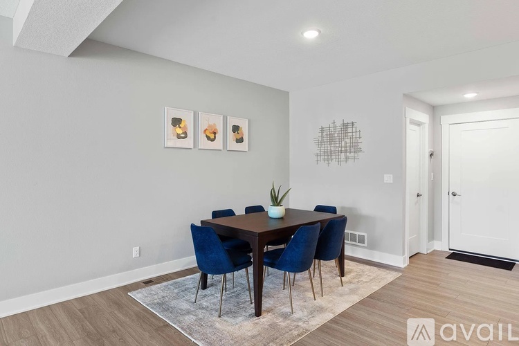 A dining room with a wooden table and blue chairs.