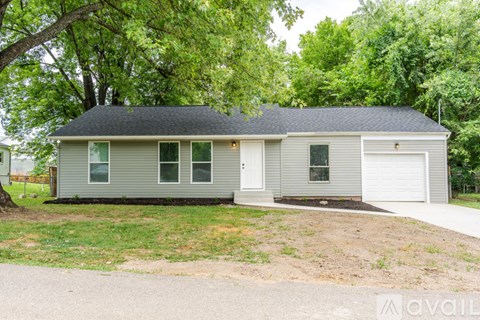 A two-story house with a garage is for sale.