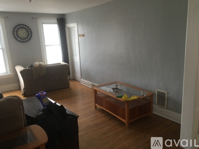 A living room with a couch, chair, and coffee table.