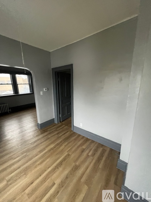 A room with wooden floors and a window.