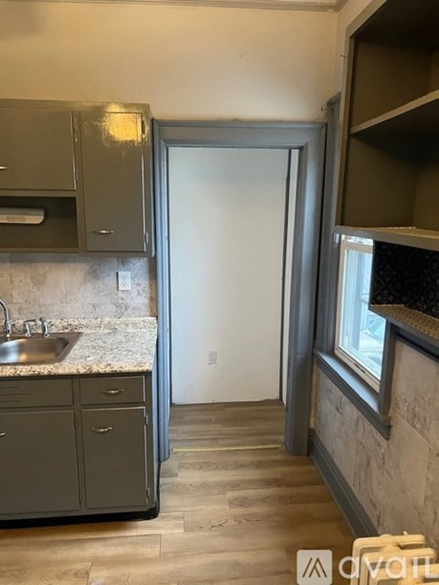 A kitchen with a sink and a refrigerator.