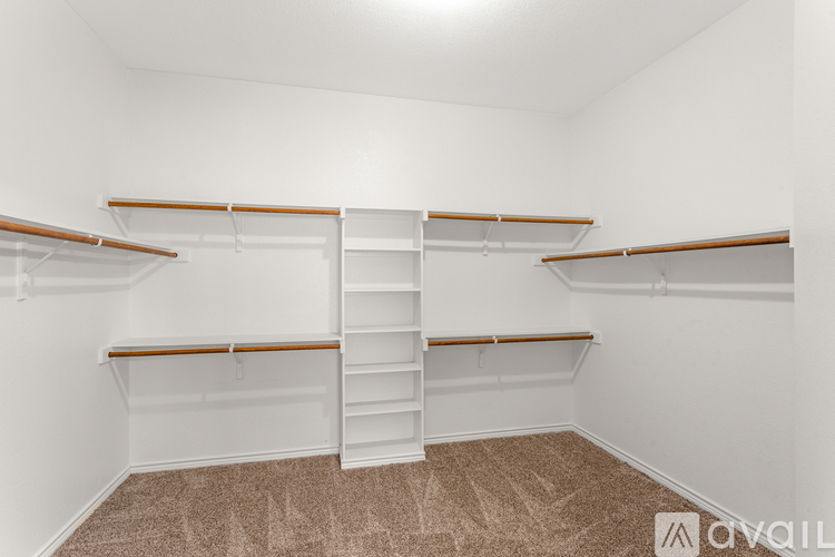 Empty room with white walls and brown carpet.