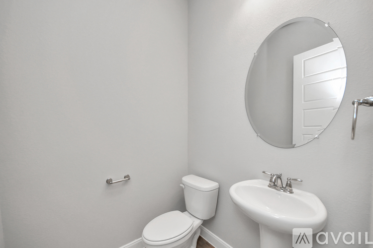 A white toilet and sink in a bathroom.