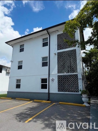A white building with a blue sky in the background.