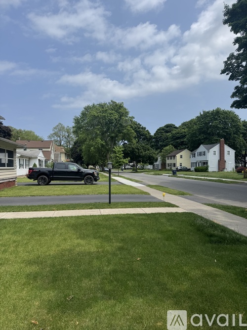 A black car is parked on the side of a street.