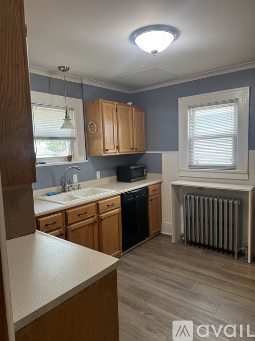 A kitchen with wooden cabinets and a white countertop.