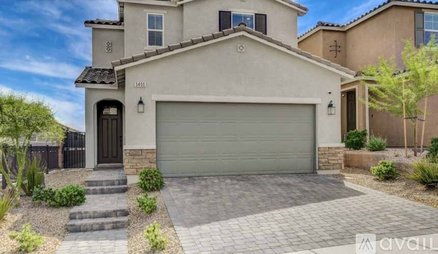 A house with a garage door and a driveway.