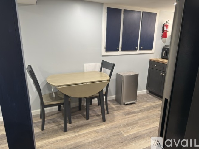 A dining area with a table and chairs.