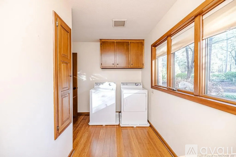 A kitchen with wooden cabinets and white appliances.