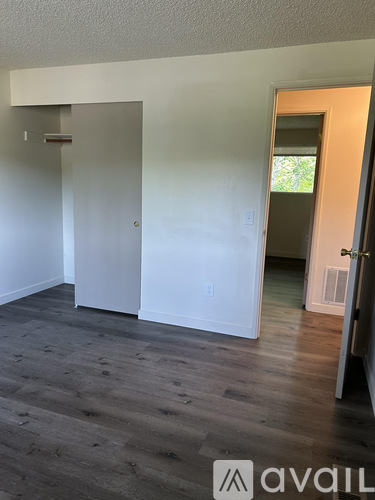 A room with a wooden floor and white walls.