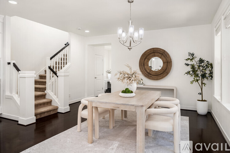 A dining room with a wooden table and chairs.