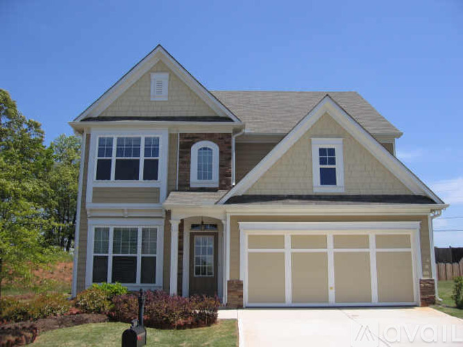 A two-story house with a garage and a brick chimney.