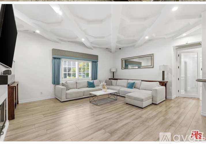 A living room with a white couch and a coffee table.