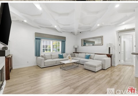 A living room with a white couch and a coffee table.