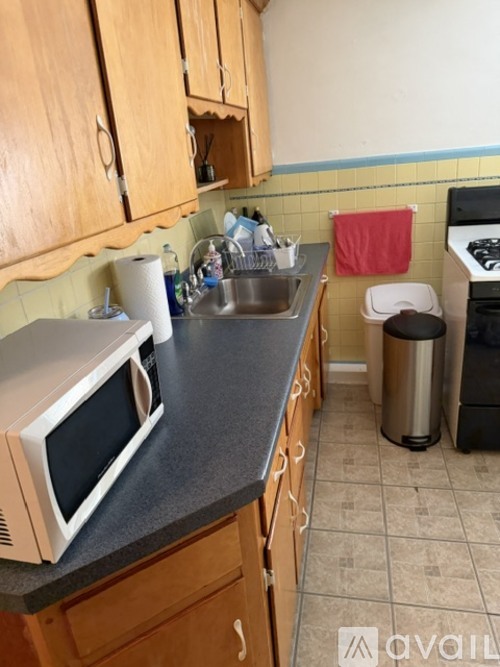 A kitchen with a microwave on the counter.