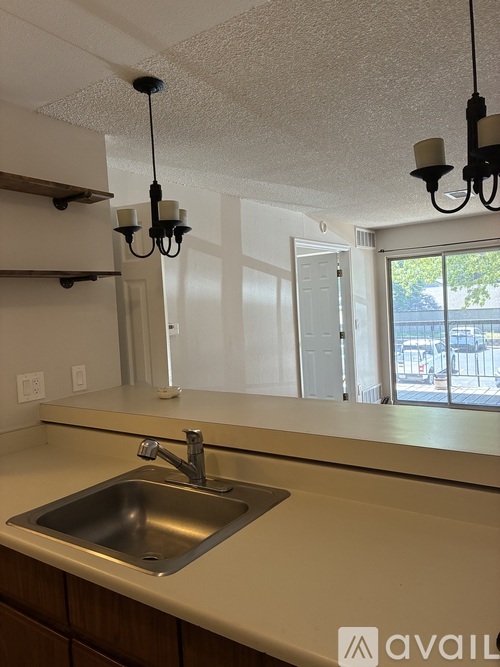 A kitchen with a sink and a window.