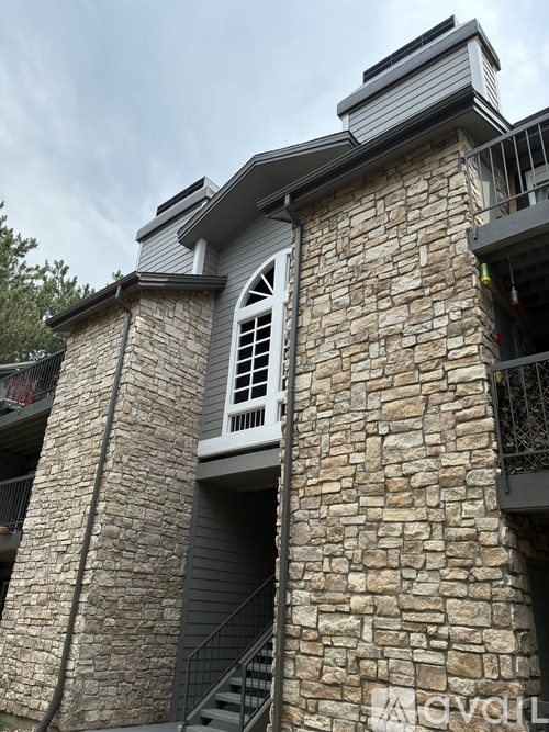 A stone building with a window and a staircase.