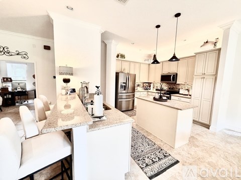 A kitchen with a white counter and a refrigerator.