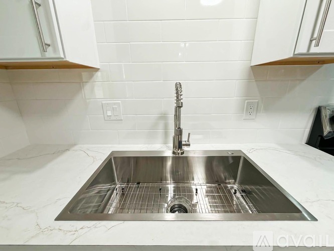 A modern kitchen sink with a chrome faucet.