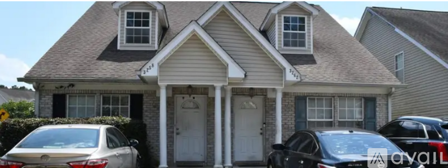 A house with a car parked in front of it.