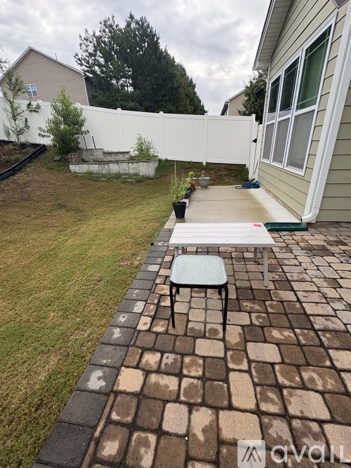 A patio with a white table and chairs.