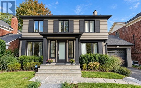 A modern house with a grey exterior and a black front door.
