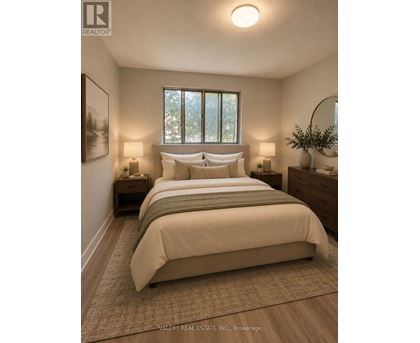 A bedroom with a large bed and two lamps.