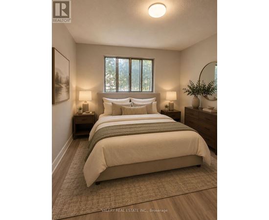 A bedroom with a large bed and two lamps.
