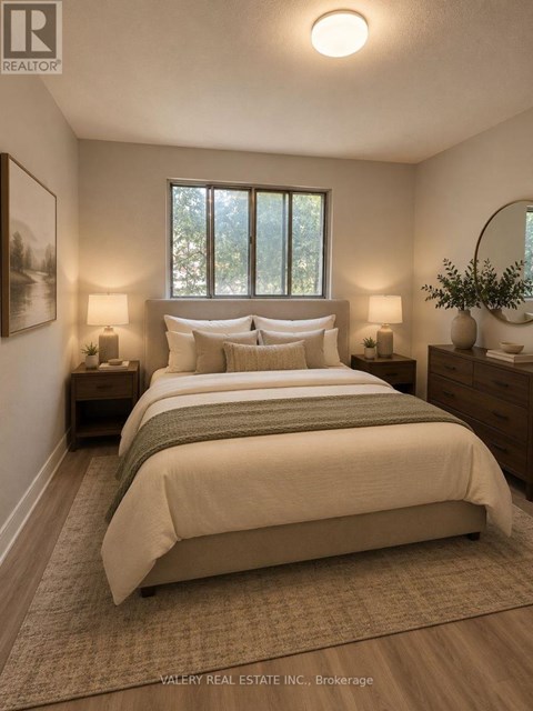 A bedroom with a large bed and two lamps.