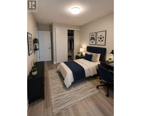 A bedroom with a bed, desk, and chair.