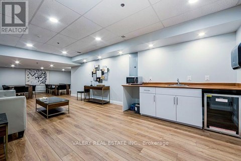 A spacious kitchen and dining area with wooden flooring and modern appliances.