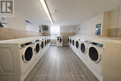 A laundromat with rows of washers and dryers.