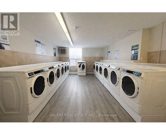 A laundromat with rows of washers and dryers.