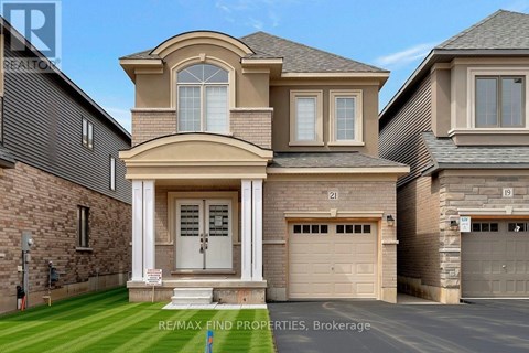 A large, two-story house with a garage is for sale.