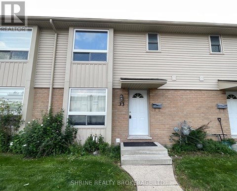 A two-story residential building with a white door and windows.