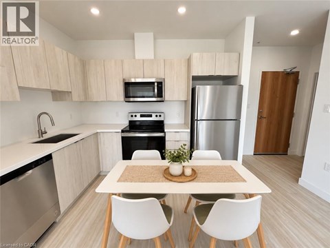 A modern kitchen with a table and chairs in the foreground.