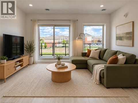 A living room with a green couch, a wooden coffee table, and a flat screen TV.
