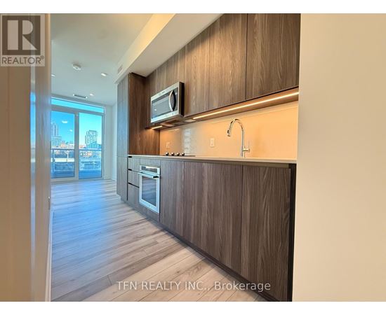 A kitchen with wood cabinets and a modern design.
