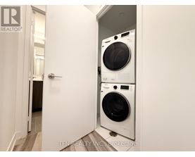 A white washing machine and dryer in a small room.
