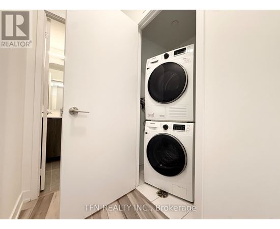 A white washing machine and dryer in a small room.