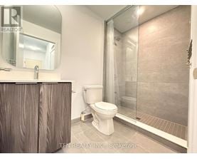 A bathroom with a toilet, sink, and shower.