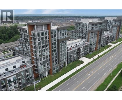 A large apartment complex with a REALTOR sign in the corner.