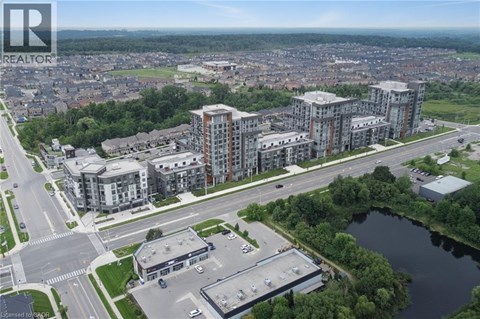A bird's eye view of a city with apartment buildings and a body of water.