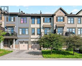 A row of townhouses with a clear blue sky above them.