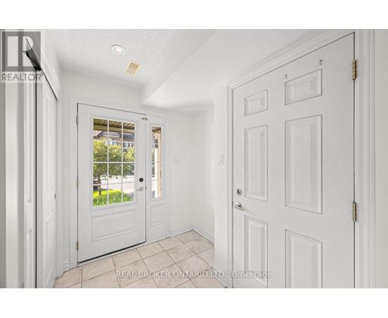 A white door with a glass window is in a room with white walls.