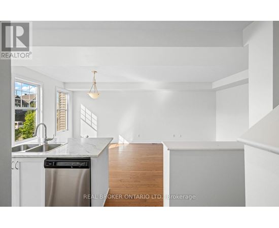 A white kitchen with a dishwasher and a sink.