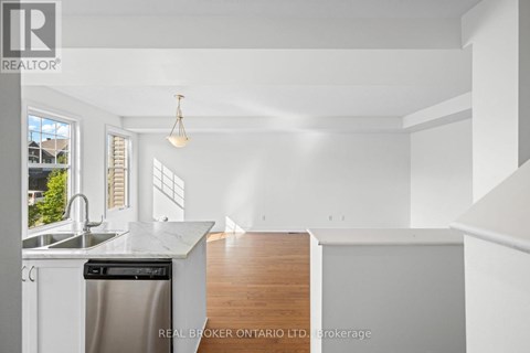 A white kitchen with a dishwasher and a sink.