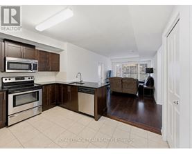A kitchen with a white tile floor and brown cabinets.