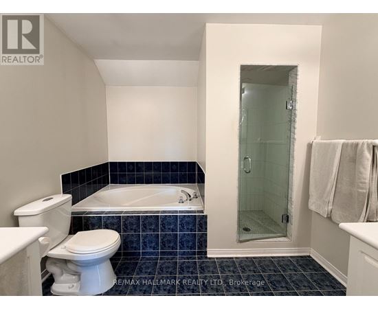 A bathroom with a white toilet and a white bathtub.
