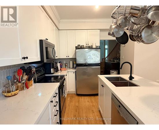 A kitchen with white cabinets and a stainless steel dishwasher.